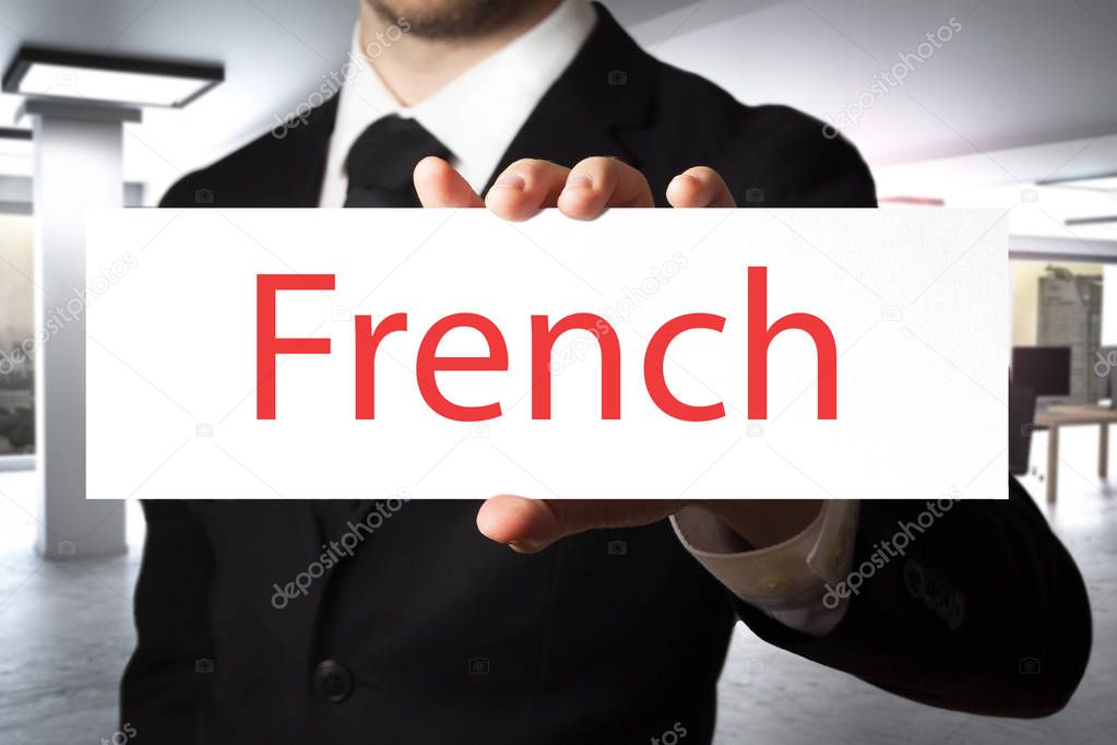 businessman in office holding sign french