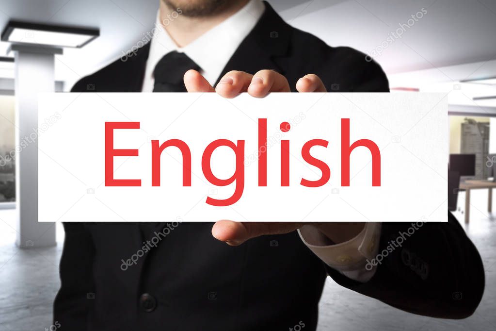 businessman in office holding sign english