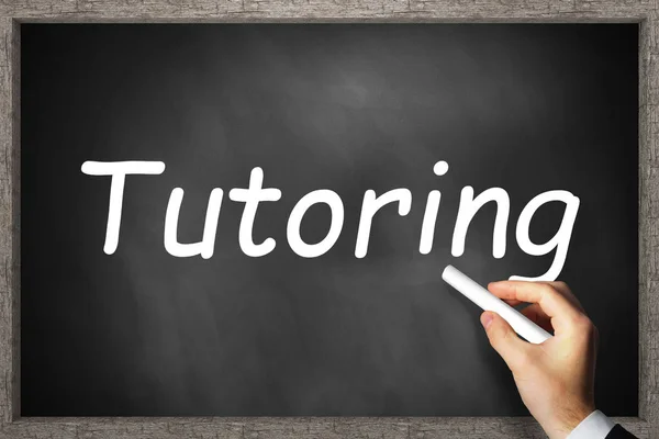 Hand writing tutoring on black chalkboard — Stock Photo, Image