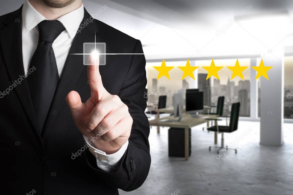 businessman in suit pushing button five star rating