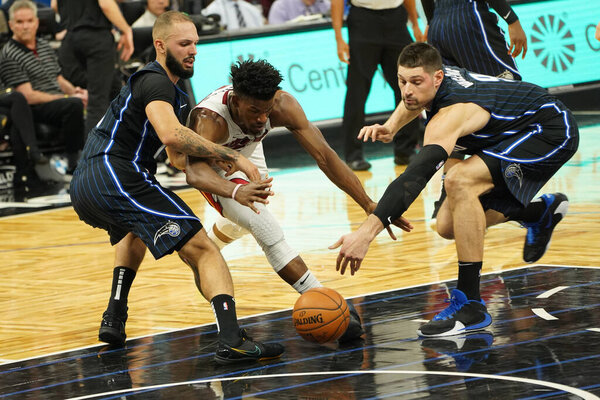 Miami Heat's Jimmy Butler attempt to retrieve the loose ball.  (Amway Center in Orlando on Friday January 3, 2020) Photo Credit:  Marty Jean-Louis
