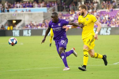 Orlando City 'den Michel Benji, 13 Temmuz 2019' da Florida, Orlando 'daki Exploria stadyumunda Columbus Crew SC' nin defans oyuncusu Josh Williams 'ı geçmeye çalışıyor. Fotoğraf: Marty Jean-Louis