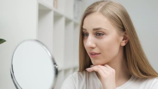 Hermosa mujer mirando en el espejo — Vídeo de stock