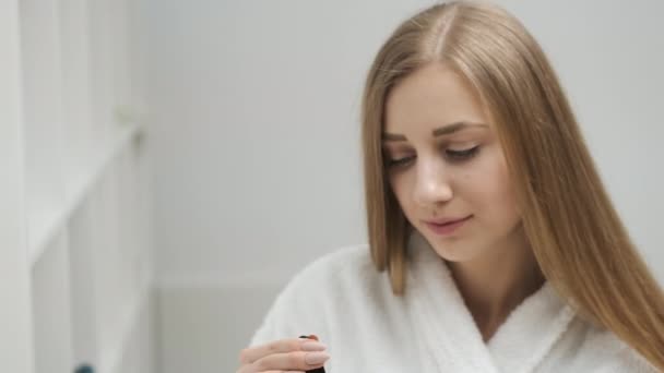 Linda linda chica aplica crema para el cuidado de la cara en los ojos — Vídeo de stock