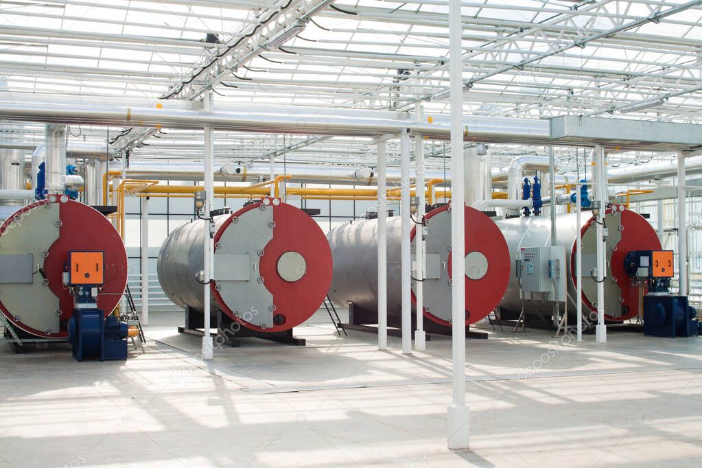 Row of industrial water boilers in a modern greenhouse