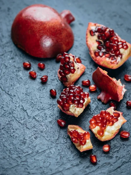 Fresh ripe pomegranate on a slate plate kitchen table — Stock Photo, Image