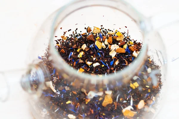 Close up of winter mix black tea tropical fruit cornflowers and spices in a teapot — Stock Photo, Image