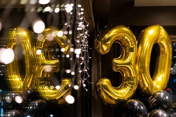 30 years gold party ballons, black background