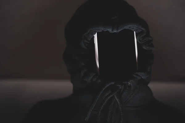 Mysterious image of a blindfolded man in a dark room stock photo