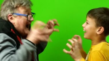 Karantina sırasında kendini izole etme. Aile içinde çocuklarla zaman geçirmek ve eğlenmek. Komik büyükbaba ve torun koruyucu sağlık maskelerini çıkarıp oynaştılar. Krom anahtar.