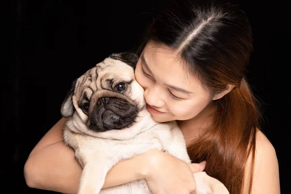 Asian woman hugging dog pud breed with love happiness emotional