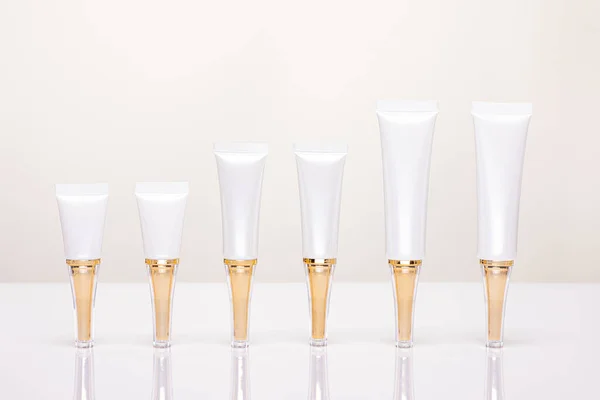 luxury white clean tubes set for cream and gel Mock up  for package design,Blank or Empty white cosmetic tube with gold cap isolated on gray background,Product Packeaging Cosmetics Concept