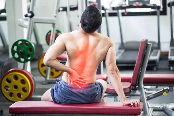 man have injury a back pain after workout in gym,Healthcare concept
