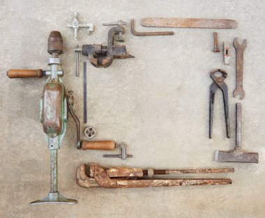 Beton yüzeyde eski inşaat aletleri var. Bir takım eski aletler ve matkap..