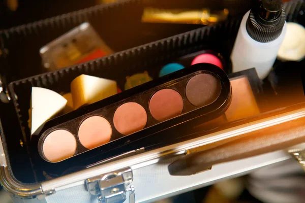 Professional makeup kit. Shadow palette, sponge, makeup artist\'s suitcase.