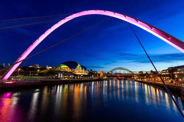 Newcastle and Gateshead at sundown showing Gateshead Millennium Bridge , sage and Tyne Bridges.