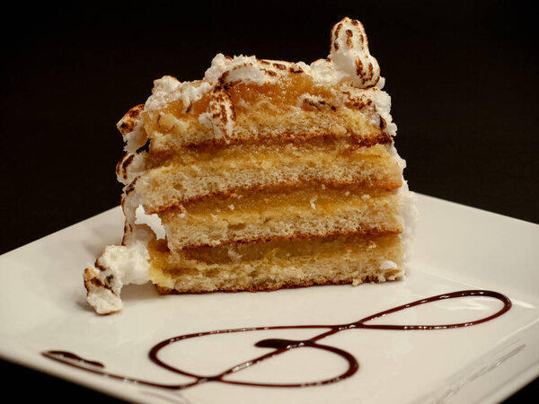 Sponge cake with meringue decorated with a chocolate treble clef