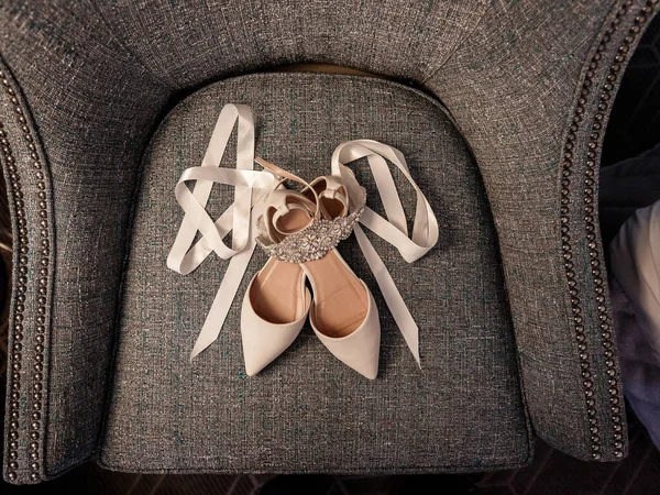 Expensive branded wedding shiny shoes. Accessories in a classic elegant interior