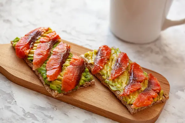 Two Sandwiches Red Fish Avocado Wooden Cutting Board — Stock Photo, Image