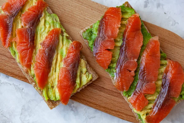 Two Sandwiches Red Fish Avocado Wooden Cutting Board — Stock Photo, Image