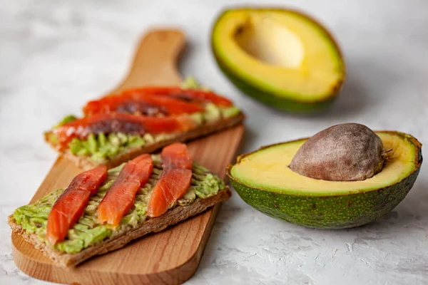 Two Sandwiches Red Fish Avocado Wooden Cutting Board — Stock Photo, Image