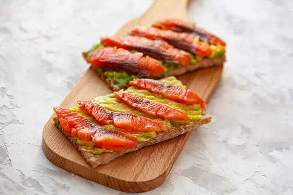 Two Sandwiches Red Fish Avocado Wooden Cutting Board — Stock Photo, Image