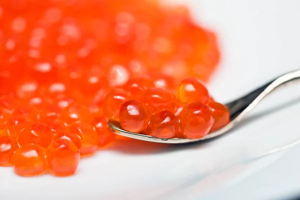 Red Caviar Grains Silver Spoon Lying White Background Stock Picture