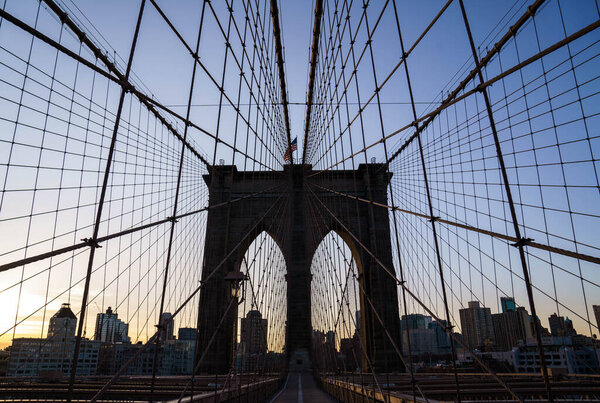 New York City, New York / USA - May 19 2020: Brooklyn Bridge. Historic landmark of New York. Bridge reflection after rain. Iron cables of Brooklyn Bridge