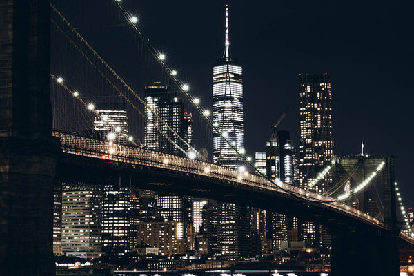 New York City, New York / USA - May 8 2020: Manhattan skyline at night. Scenic view of New York City and Brooklyn bridge at night. High quality image night New York City