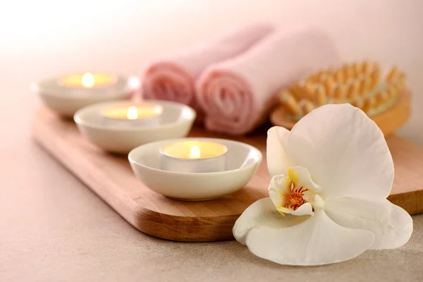 Spa concept with burning aromatic candles and white orchid Stock Image