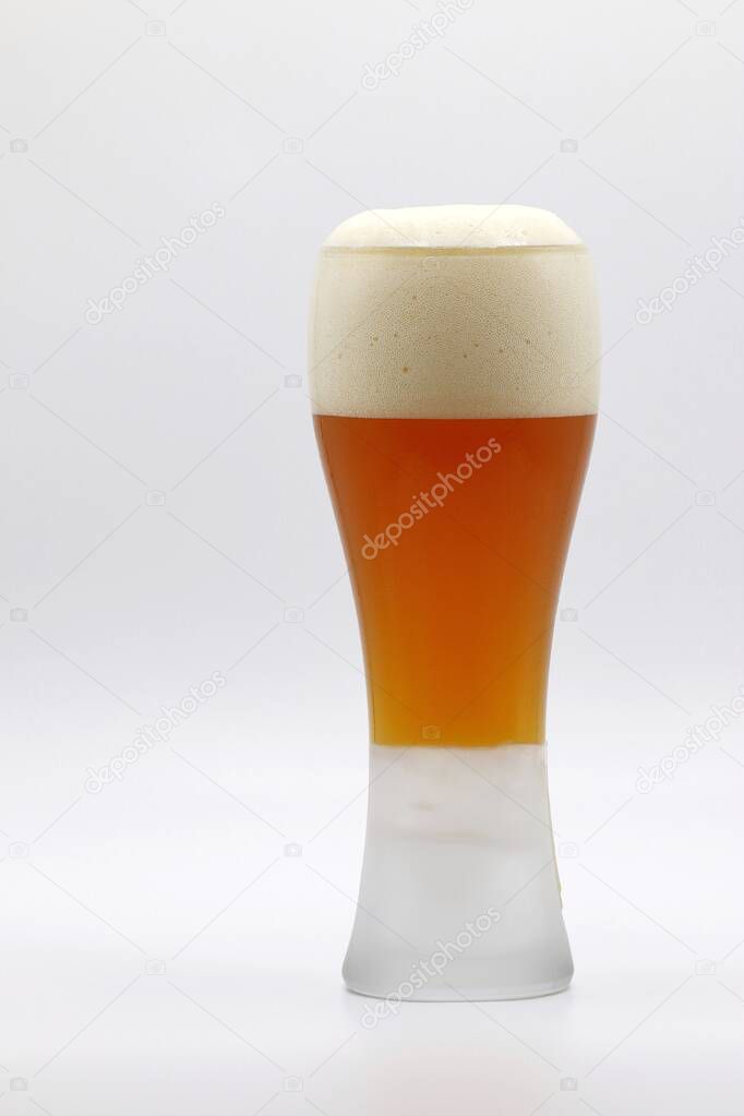 A mug of beers with foams on white background in celebration and after work concept.