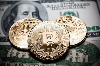 Bitcoin. Altın Bitcoins bir yüz dolarlık banknot üzerinde kapat