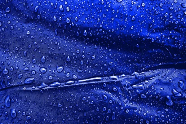 Water drops on fabric. Water drops on blue background. Condensate. Water drops background.