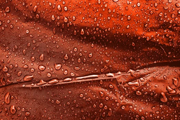 Water drops on the fabric. Water drops on red background. Condensate. Water drops background.