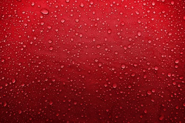 Water drops on the fabric. Water drops on red background. Condensate. Water drops background.