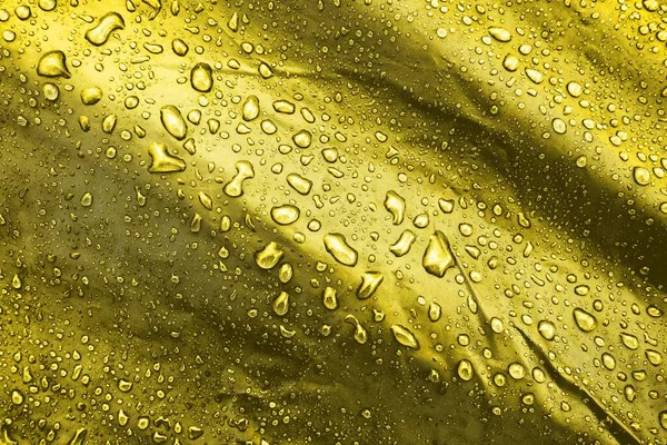 Water drops on the fabric. Water drops on yellow background. Condensate. Water drops background.