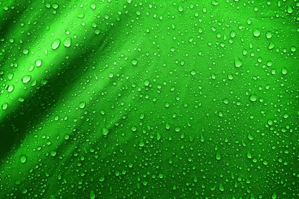 Water drops on fabric. Water drops on green background. Condensate. Water drops background.