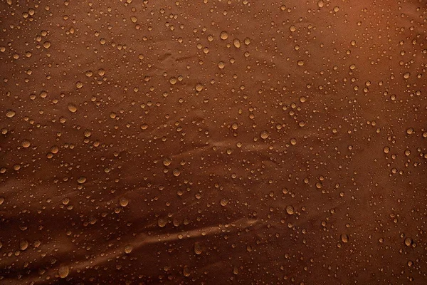 Water drops on fabric. Water drops on brown background. Condensate. Water drops background.