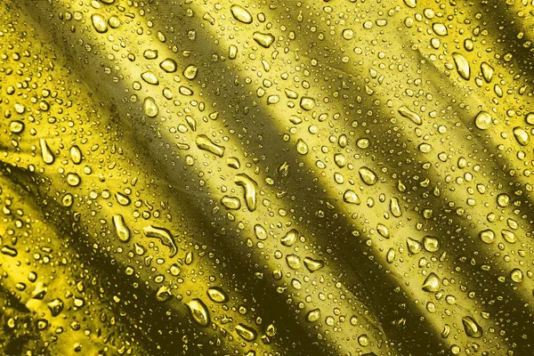 Water drops on the fabric. Water drops on yellow background. Condensate. Water drops background.