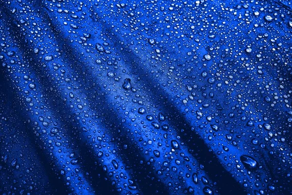 Water drops on fabric. Water drops on blue background. Condensate. Water drops background.