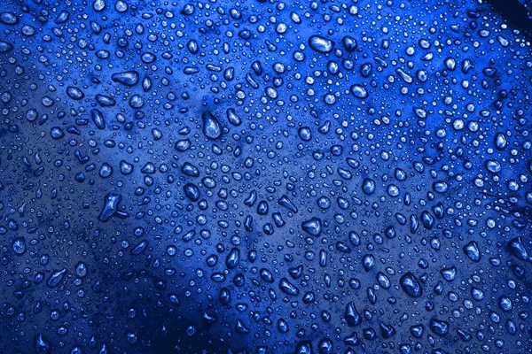 Water drops on fabric. Water drops on blue background. Condensate. Water drops background.