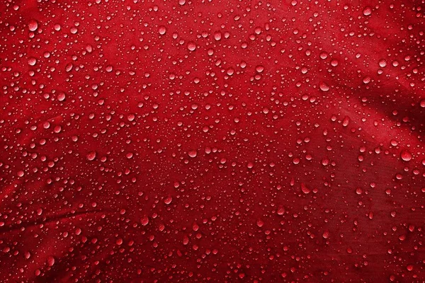 Water drops on fabric. Water drops on red background. Condensate. Water drops background.