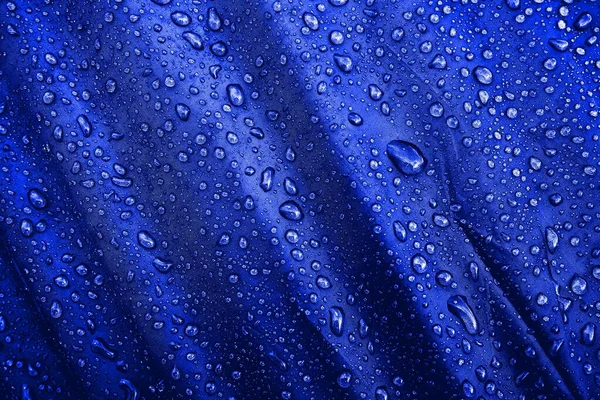 水滴在织物上 水滴在蓝色的背景上 凝固汽油 水滴背景 — 图库照片