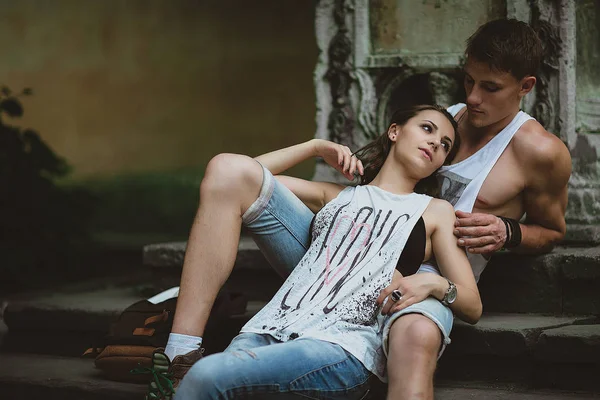 Young beautiful funny couple in love having fun outdoor on the street in summer