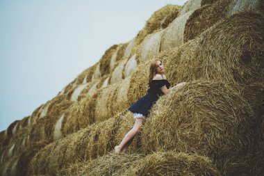 Güneşli gün saman yığınında Tarih mutlu bir kadın. Güzellik romantik kız açık havada karşı. Seksi esmer haystacks bir alana ait fotoğraf