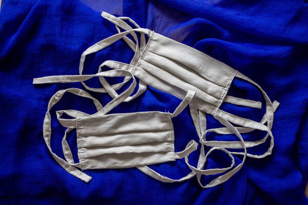 white handsewn facemasks on blue background