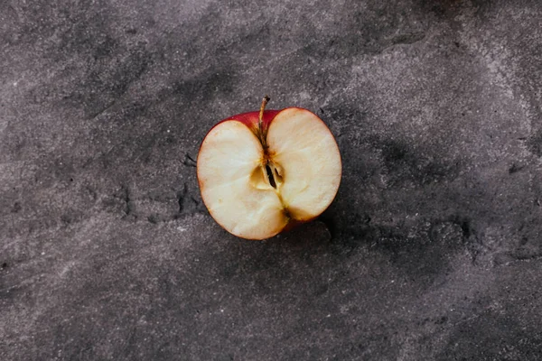 half apple on a gray background