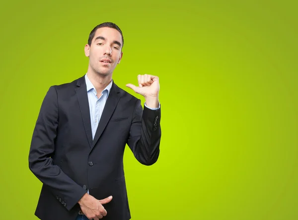 Proud businessman pointing to himself on green background