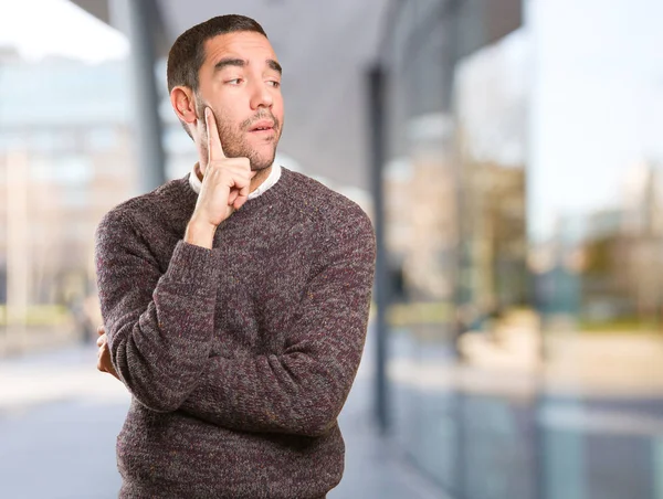 Young man doing a doubt gesture