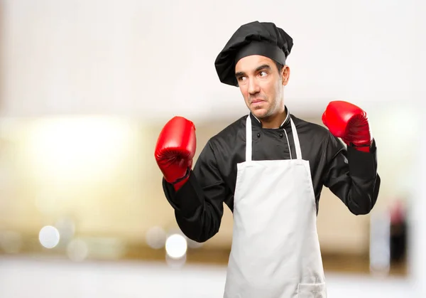 Angry chef using a boxing gloves